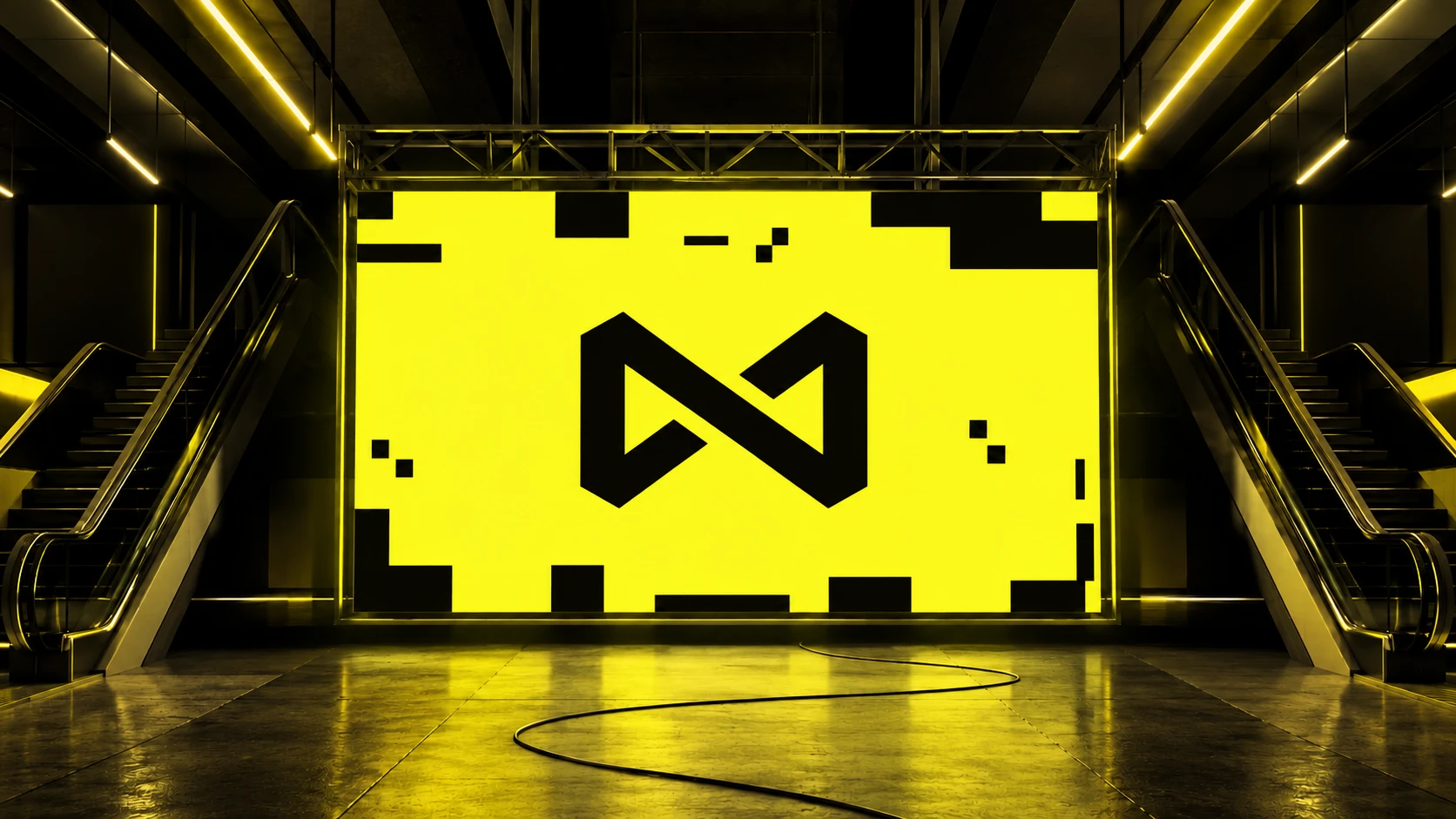 A yellow LED wall on a steel truss showing the Mediatrix mark, between two escalators